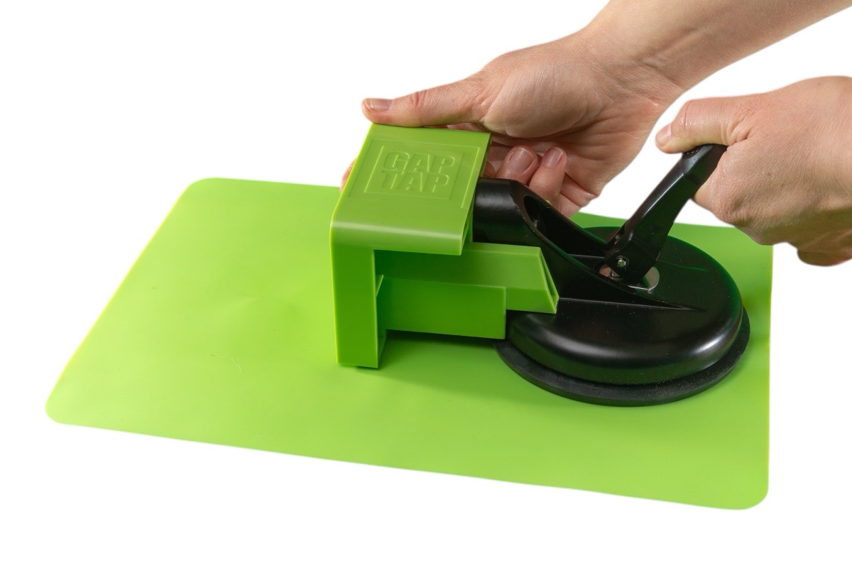 Locking the Gap Tap suction cup onto a floor plank